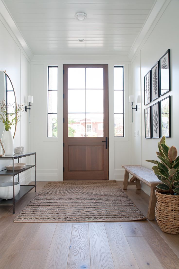 a white room with a wooden door and bench