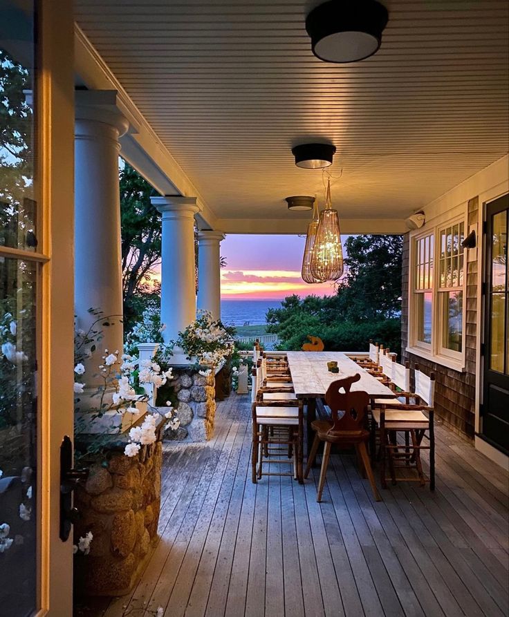 an outdoor table and chairs on a porch