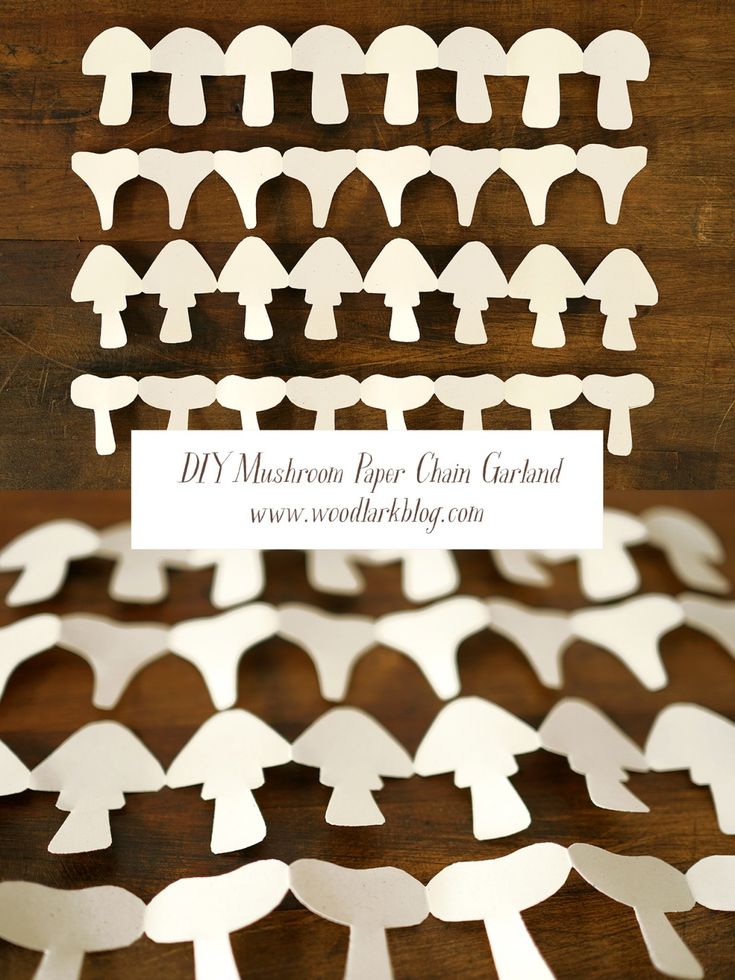 white paper cutouts are arranged on a wooden surface