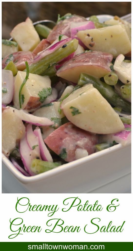 a white bowl filled with potato salad on top of a table