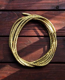 a yellow rope on top of a wooden floor