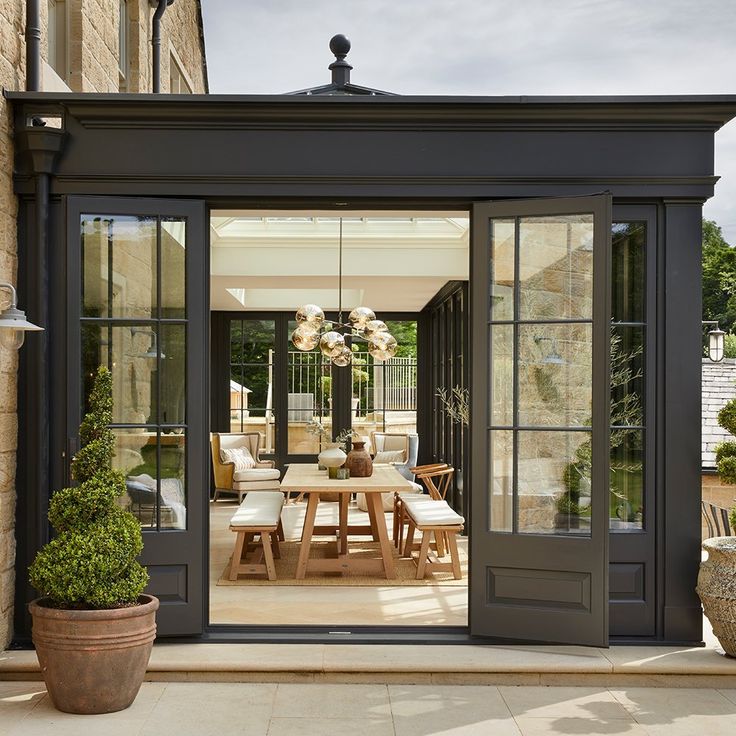 an outdoor dining area with french doors leading to the patio