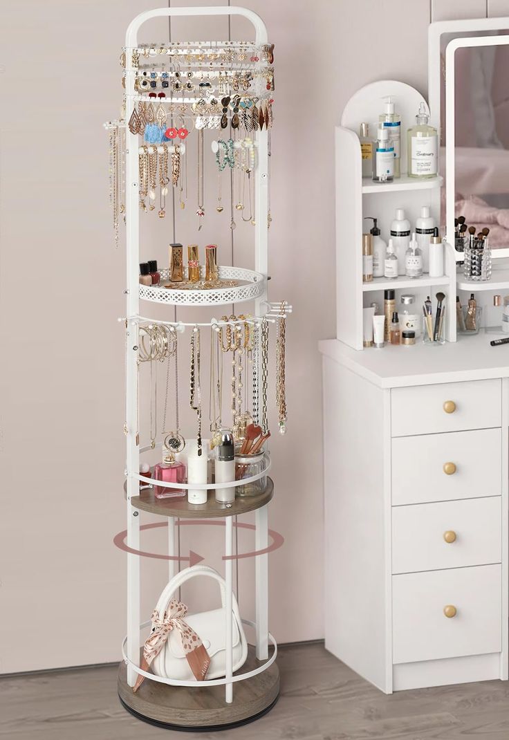 a white jewelry rack sitting next to a dresser