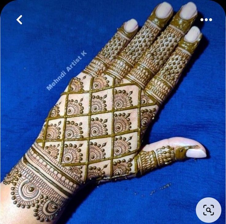 a woman's hand with henna on it