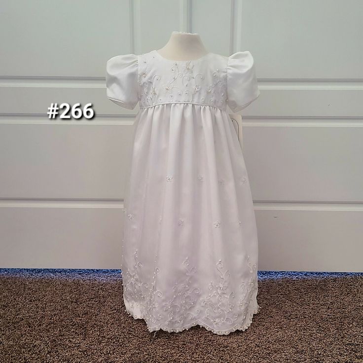 White Silk Baby/Toddler Dress. Embellished With Embroidered, Beaded Flowers. Gathered Short Sleeves And Bodice. Satin Ribbon Ties In The Back. 4 Layered Underskirt With Tulle. Buttons All The Way Up The Back. Perfect For A Flower Girl, Baptism, Christening Or Baptism. Fouger Brand. New With Tags Still Attached. Available In Size 18 Months And Size 24 Months. Short Sleeve Embroidered Dress For Baptism, White Floral Applique First Communion Dress, Fitted Baptism Dress With Floral Applique For Dress-up, Pageant Baptism Dress With Floral Applique, White Short Sleeve Baptism Dress, White Floral Embroidered Dress For Baptism, Fitted Short Sleeve Baptism Dress For Pageants, Fitted Short Sleeve Baptism Dress For Pageant, White Short Sleeve First Communion Dress For Pageant