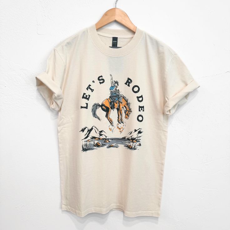 Let's Rodeo Unisex/Mens Tee - Faded Ecru - The Montana Scene Kids Onesies, Kids Beanies, Sock Gifts, Kid Tees, Heavy Weight, Mens Tees, Rodeo, Kids Hoodie, All Rights Reserved