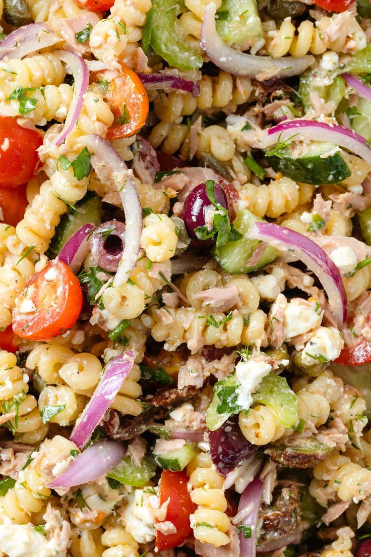 a salad with corn, tomatoes, onions and cucumbers