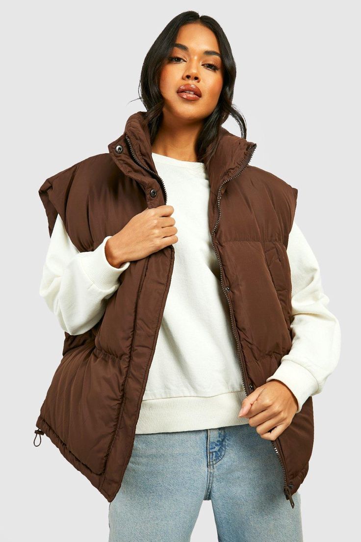 Womens Oversized Boxy Vest - Brown - 6 - Add a different type of layer to your look with this vest, a sporty and stylish piece. This sleeveless jacket closely resembles a waistcoat and is perfect for throwing over long sleeve tops, sweaters, and lightweight coats. This body warmer can add that much-needed extra insulation to your outfit during colder months without making you feel too bulky. Style this women's vest with a sports outfit, work attire, or everyday look.Style: GiletLength: RegularSl Vest Jacket Outfit, Jacket Without Sleeves, Sleevless Jacket, Boxy Vest, Puffer Vest Outfit, Waistcoat Designs, Sports Outfit, Outfit Work, Brown Vest