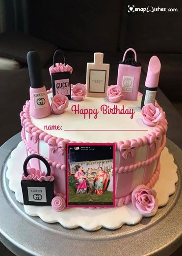 a birthday cake with pink decorations and pictures on it