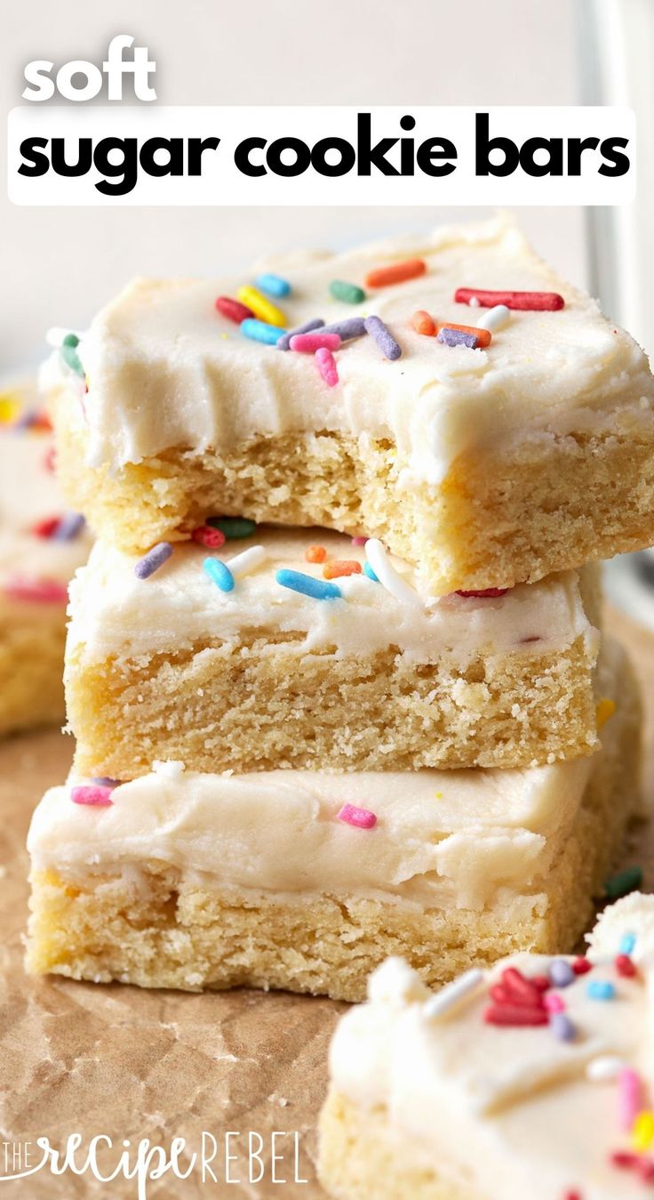 three sugar cookie bars with frosting and sprinkles stacked on top of each other