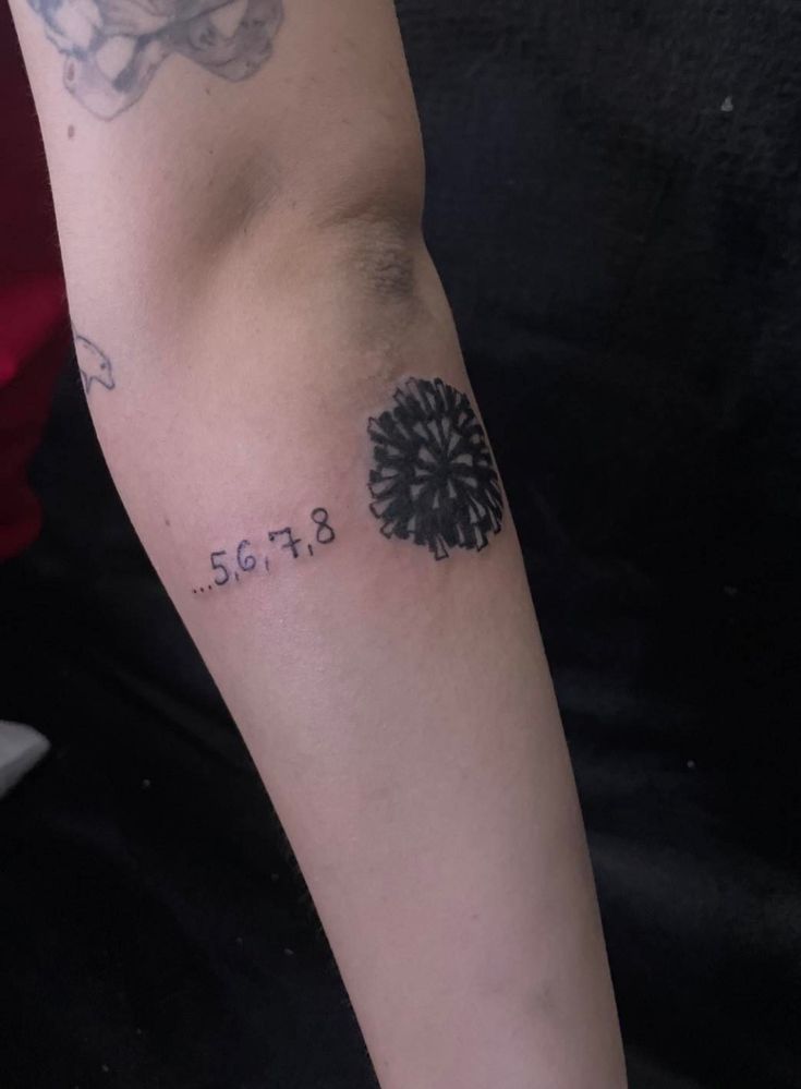 a person with a tattoo on their arm that says, 507a and has a flower in it