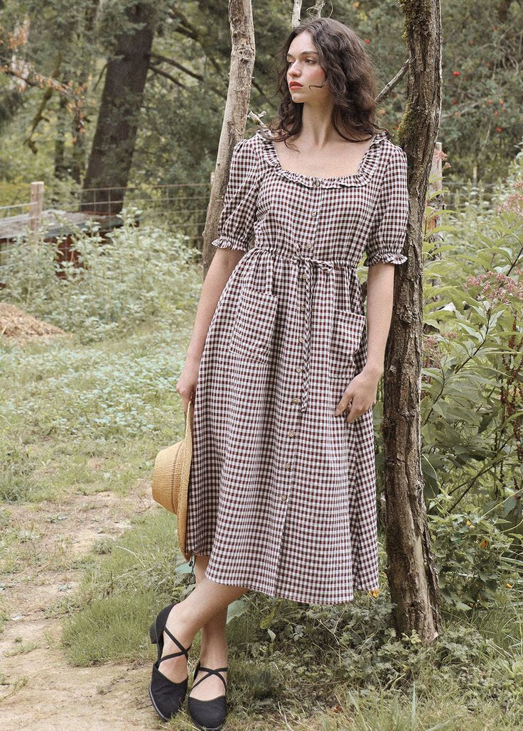 Inspired by sweet country frocks from my childhood, the Abighaile is made of a maroon gingham checked and features softly squared front and back neckline with ruffle accent, short puffed sleeves finished with a flounce, an adjustable drawstring waist, and two front patch pockets. The Abighaile has a row of wooden buttons down the front for closure. Material 100% Polyester Sheerness:❦❦❦❦❦ - 5 out of 5 - Not Sheer Garment CareFor best results, gently hand wash and lay flat to dry Production Made w Brown Gingham, Quaint Cottage, Wooden Buttons, Dress Measurements, Gingham Dress, My Childhood, Gingham Check, Button Down Dress, Light Texture