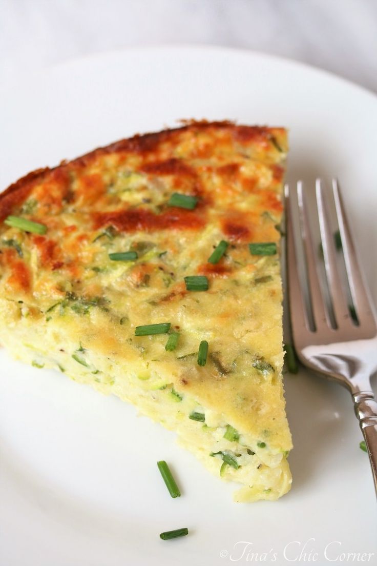 a slice of quiche on a plate with a fork