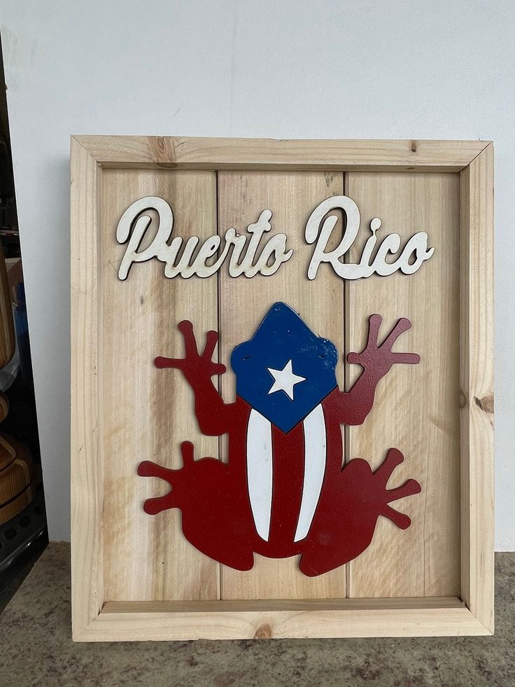 a wooden sign that says puerto rico with a frog on it's back and the words puerto rico written in spanish