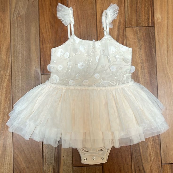 Made For Your Little Ballerina, The Tutu Features A Leotard And A Full Tiered Tulle Skirt. Adorned In Dainty Beading In The Front, And Adjustable Ruffle Shoulder Straps. Size 6 But Looks Like A 4-5t Summer Lace Tutu Dress For Dress-up, Summer Tutu Dress With Ruffles For Dress-up, Fitted Baptism Dress For Summer, Summer Dress-up Tutu Dress, Sleeveless Tutu Dress For Summer, Spring Baptism Dress Fitted For Party, Spring Baptism Dress For Party, Fitted Summer Baptism Dress, Spring Baptism Party Dress Fitted