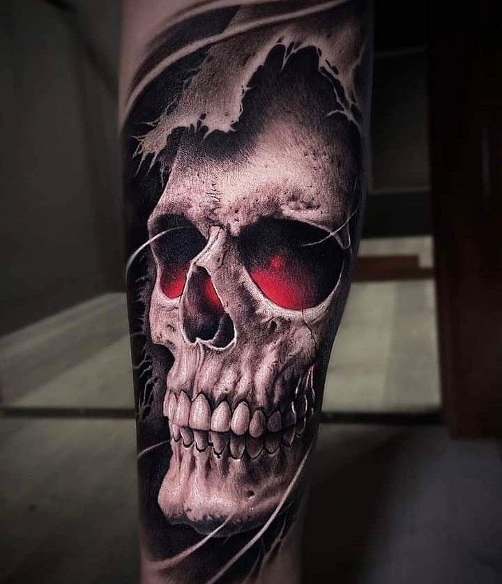 a man's leg with a skull and red eyes