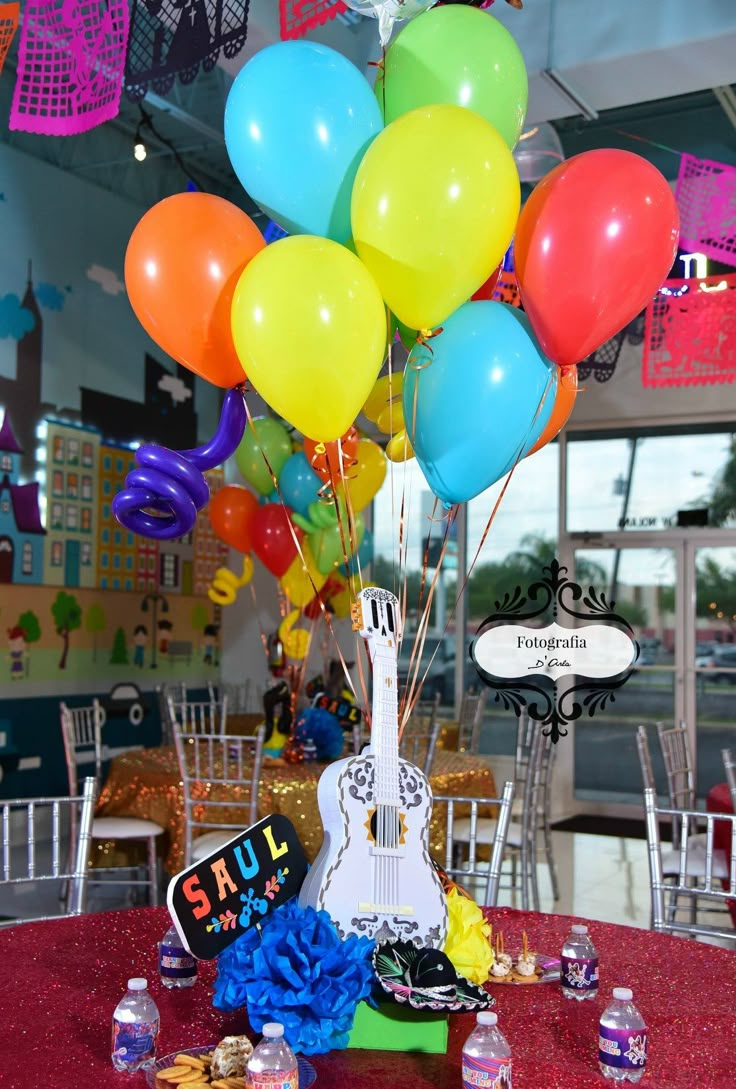 there is a guitar and balloons on the table