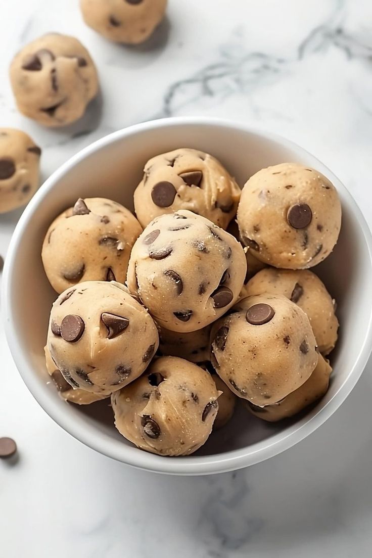 a white bowl filled with chocolate chip cookies