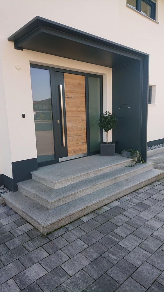 the entrance to a building with steps leading up to it and a potted plant