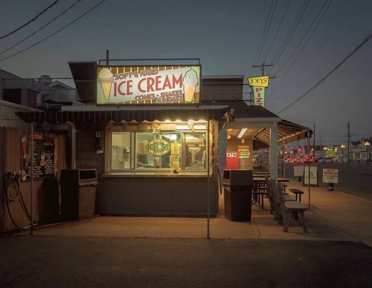 an ice cream shop with neon lights on the front