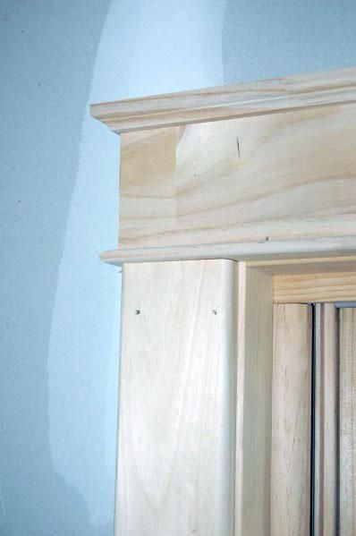 an unfinished wooden cabinet door is shown in the corner of a room with blue walls