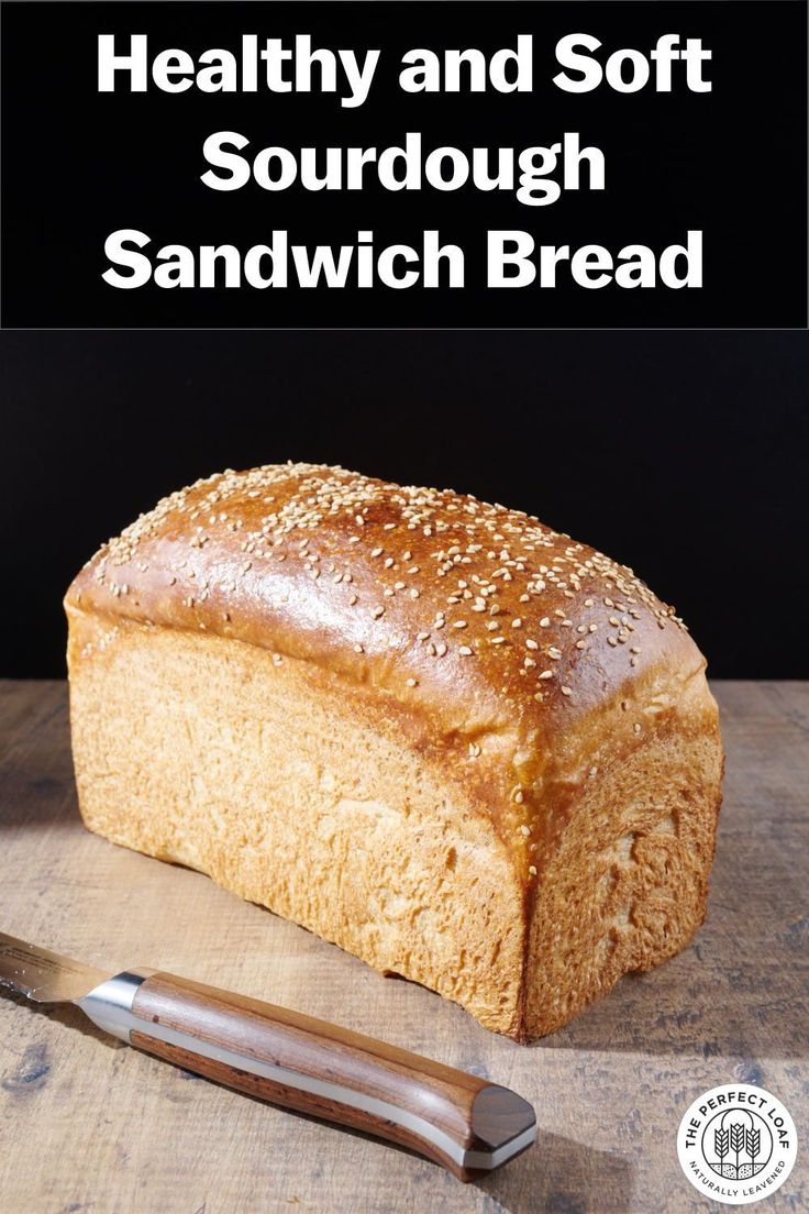 a loaf of bread sitting on top of a wooden cutting board next to a knife