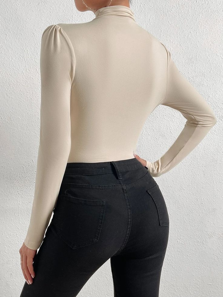 Introducing our stylish and chic Mock Neck Ruched Bodysuit - a must-have for any fashion-conscious woman who wants to make a statement. This elegant bodysuit is made of high-quality knitted fabric that offers superior comfort and flexibility. The slim-fit design features a stand collar and long sleeves that add a touch of sophistication to your wardrobe. The mock neck design highlights your neck and adds a refined touch to your outfit. Features: Color: Apricot Style: Elegant Pattern Type: Plain Type: Tee Neckline: Stand Collar Details: Wrap Sleeve Length: Long Sleeve Sleeve Type: Regular Sleeve Waist Line: Natural Fit Type: Slim Fit Fabric: High Stretch Material: Knitted Fabric Composition: 95% Polyester, 5% Elastane Care Instructions: Machine wash or professional dry clean Sheer: No Featu Solid High Waist High Stretch Bodysuit, High Stretch High Waist Bodysuit, Elegant Stretch Bodysuit Solid Color, Solid High Waist Bodysuit For Fall, Chic Ribbed High Stretch Bodysuit, Chic Beige Bodysuit For Fall, Trendy Solid Stretch Bodysuit, Trendy Stretch Bodysuit For Workwear, Chic High Neck Bodycon Top