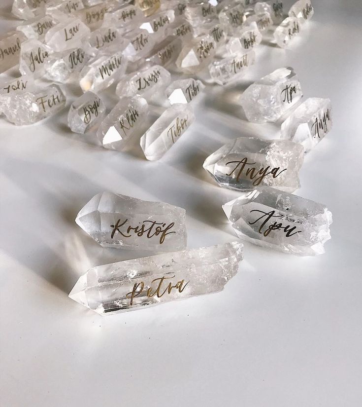 several pieces of clear crystal with writing on them sitting on a white counter top next to each other