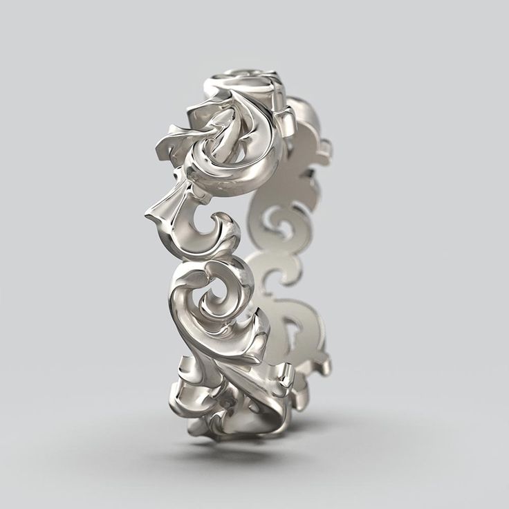 an intricately designed wedding ring on a gray background