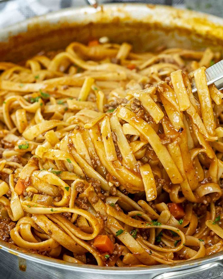 a large pot filled with pasta and meat