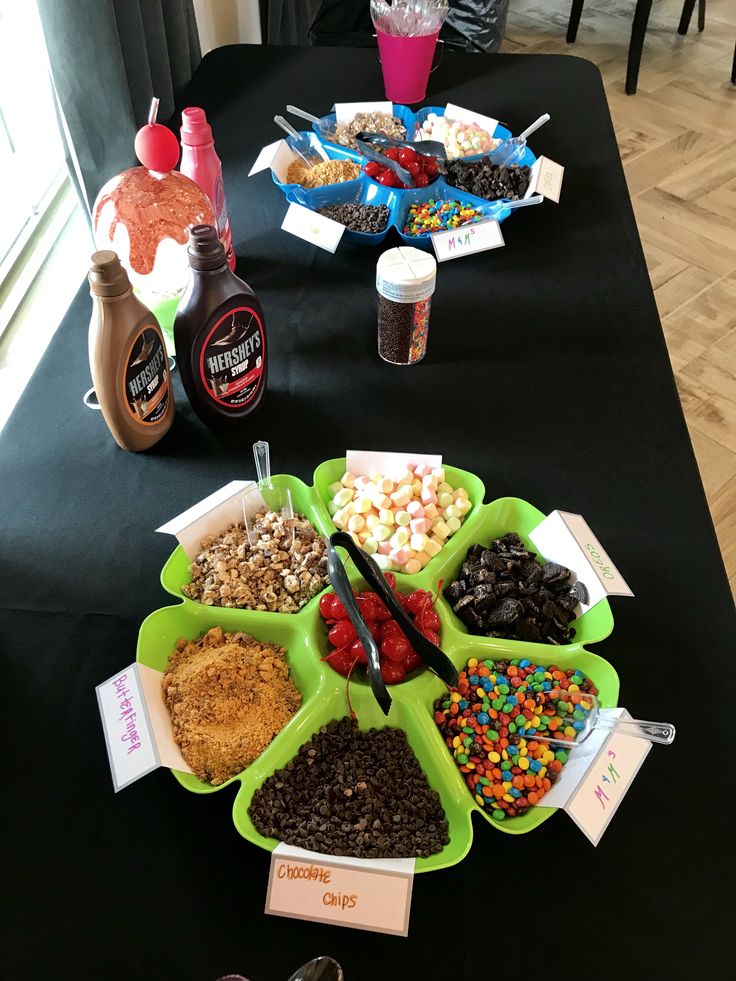 a table topped with bowls filled with different types of candy and confection items