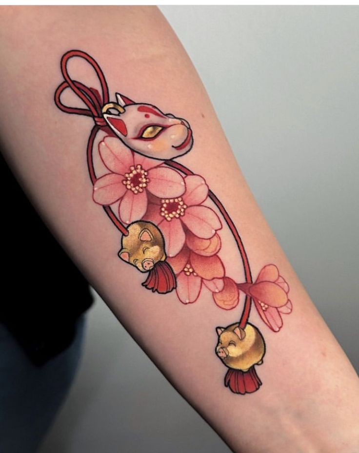 a woman's arm with flowers and cats on it