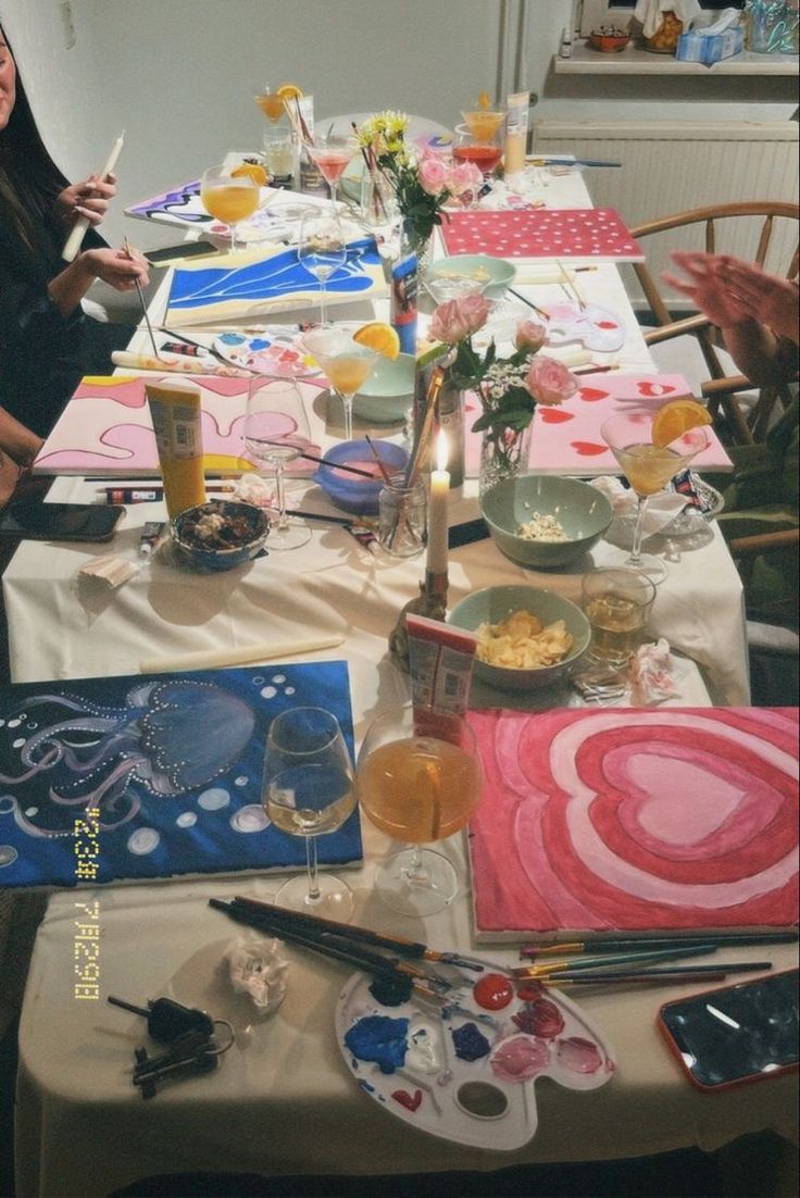 a group of people sitting around a table with plates and glasses on top of it