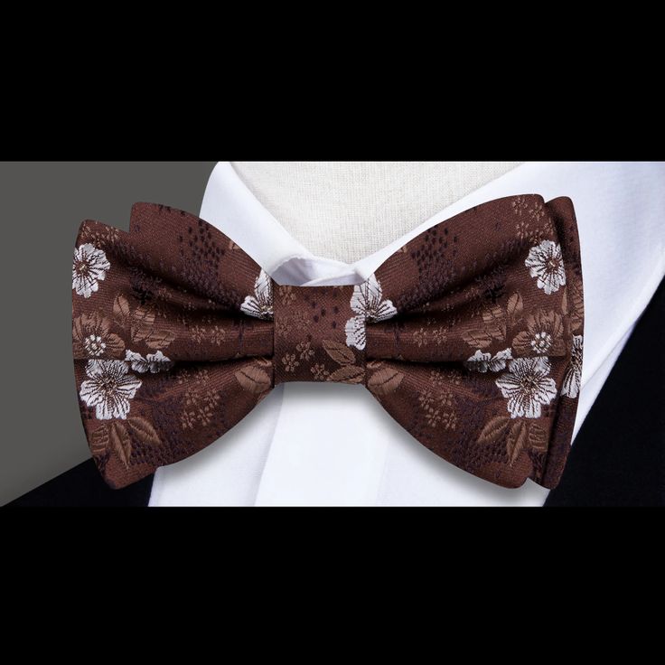 Elevate Your Style with the Distinguished Brown and White Floral Silk Bow Tie In the realm of men's fashion, few accessories exude elegance and refinement quite like a silk bow tie. The epitome of sartorial sophistication, a well-chosen bow tie has the power to transform an outfit from ordinary to extraordinary. Introducing our latest addition to the collection: the stunning Shades of Brown and White Floral Silk Bow Tie. Crafted from luxurious silk, this bow tie boasts a captivating pattern of s Elegant Brown Bow Ties, Elegant Pre-tied Bow For Gift, Pre-tied Bow For Black Tie Occasion, Dapper Suit And Tie Accessories With Detachable Bow, Formal Pre-tied Bow Tie With Butterfly Knot, Formal Pre-tied Bow Tie, Summer Formal Pre-tied Bow Tie, Elegant Fitted Bow For Gift, Elegant Summer Bow For Gifts