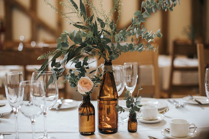 the table is set with wine bottles and glasses