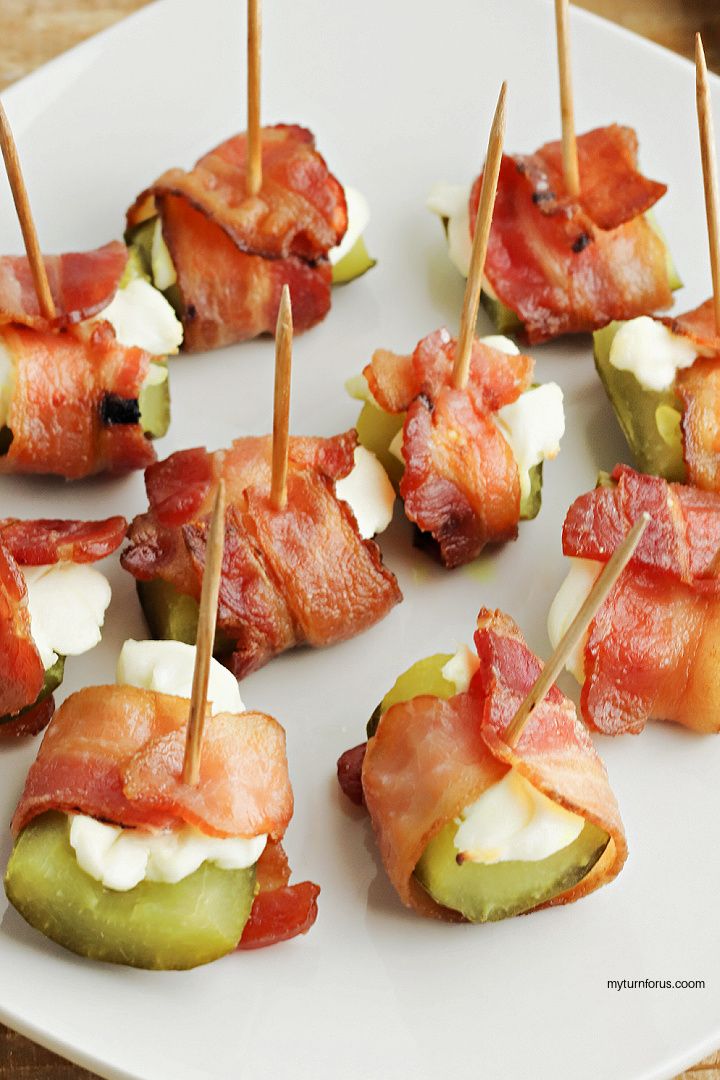 small appetizers with bacon, cheese and pickles on a white plate