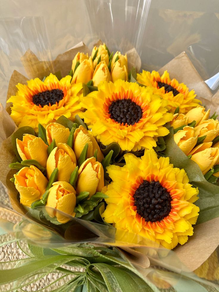 a bouquet of yellow flowers sitting on top of a table