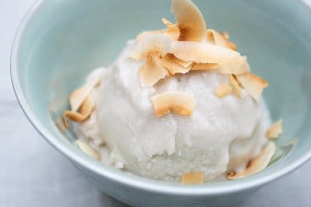 a bowl filled with ice cream topped with nuts