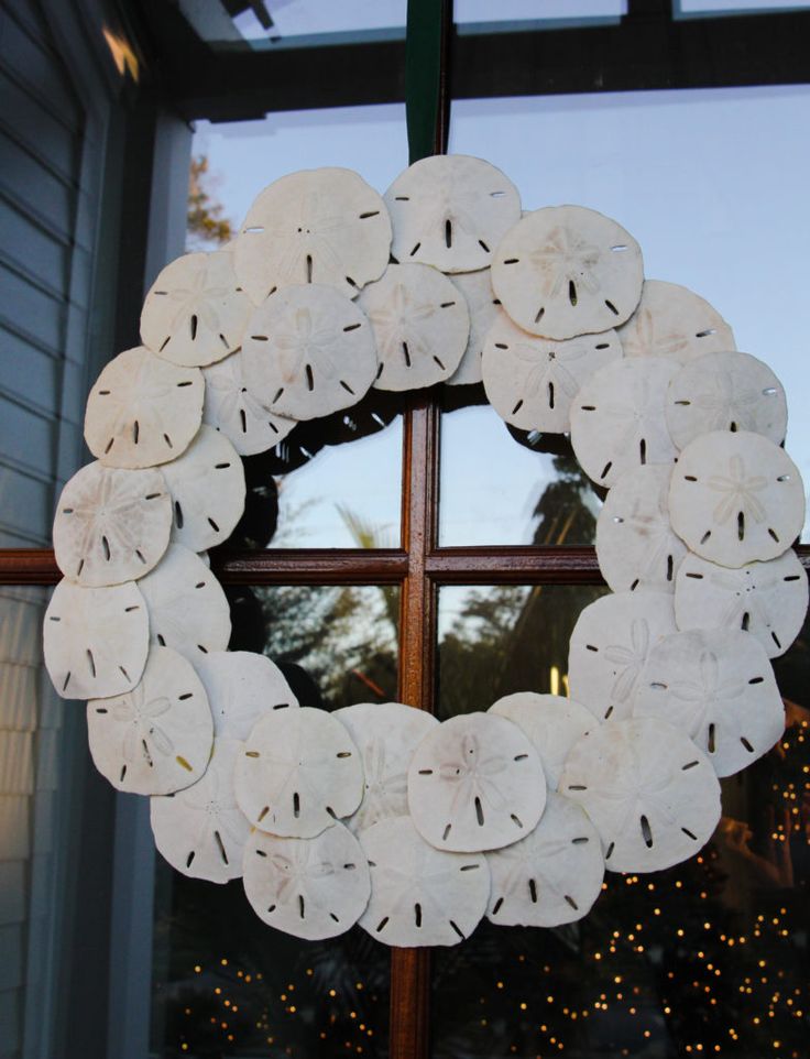 a wreath made out of toilet paper sitting on top of a window sill