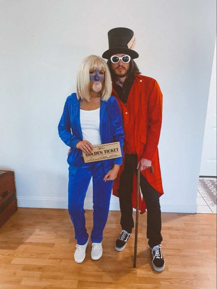 a man and woman dressed in costumes standing next to each other