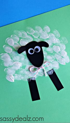 a sheep made out of bubble wrappers sitting on top of a green sheet of paper