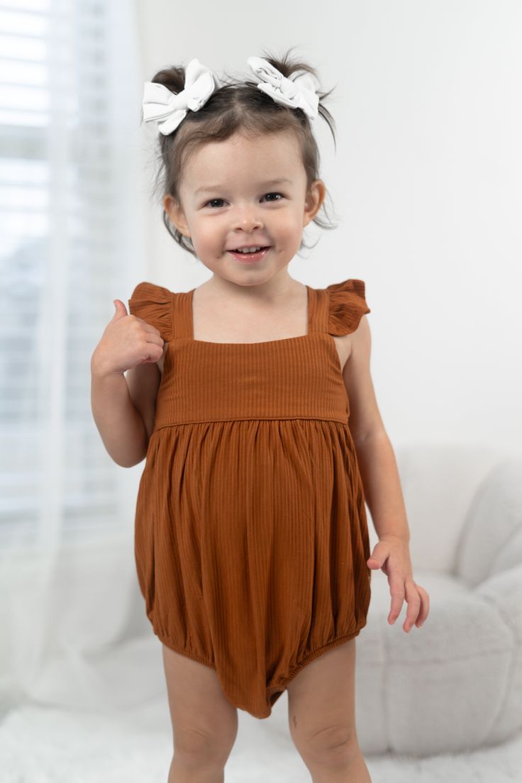 Get ready to have the sweetest dreams in our Copper Rib Dream Bubble Romper. Made from soft copper rib material, this sleeveless romper is perfect for spring and summer weather. The dreamy bubble design adds a playful touch, while the neutral color makes it easy to mix and match with your favorite accessories. Unleash your inner fun and quirky side in this romper that will have you feeling stylish and comfortable. Made from the softest and most breathable bamboo viscose material, your babe won't Sweetest Dreams, Toddler Flower Girls, Girls Gloves, Bubble Design, Girls Dress Outfits, Toddler Flower Girl Dresses, Infant Flower Girl Dress, Tea Party Dress