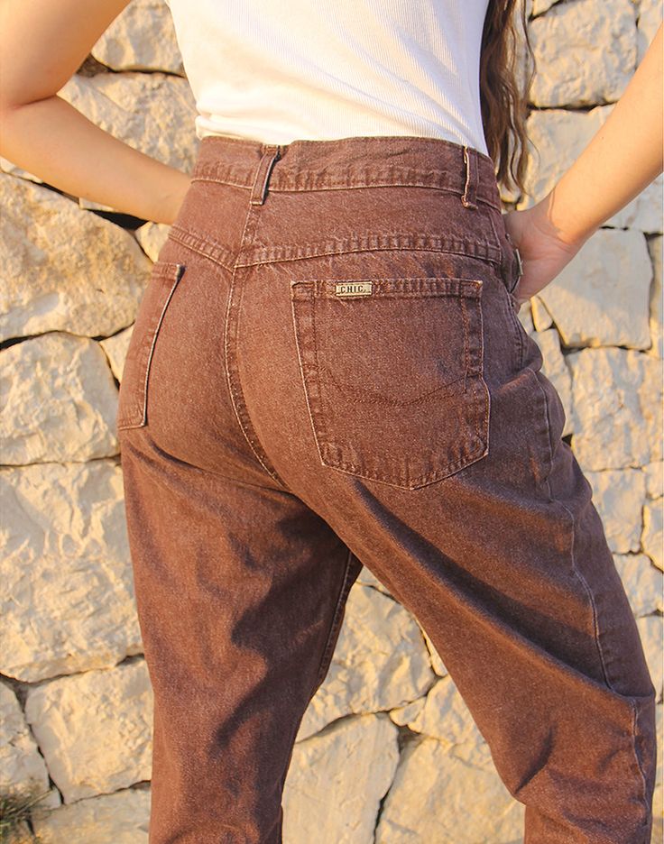 Mom jeans in brown. High rise. Zipper fly. Front and back pockets. Tapered leg. Size EU 40 / UK 12 Actual measurements - 30"(76cm) waist - 40"(102cm) hips - 30.5"(77cm) inner leg - 13"(33cm). Composition - 100% Cotton Condition - Excellent. Sustainability - Vintage Handpicked, repaired and ready to wear. This is an original vintage item, not new and minor signs of wear and age are expected, we will highlight any major flaws. Model is a size UK 6/8 and is 5'7" tall Brown Straight Leg Jeans With Belt Loops, Brown Jeans With Belt Loops For Fall, Brown Fall Jeans With Belt Loops, Brown Jeans With Belt Loops, Brown Full Length Jeans With Belt Loops, High Rise Brown Cargo Pants, High Waist Brown Pants With Five Pockets, Mid-rise Brown Cotton Jeans, Mid-rise Brown Pants With Hip Pockets