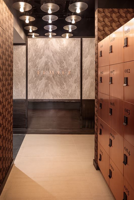 the lockers are lined up against the wall with numbers on them and lights above