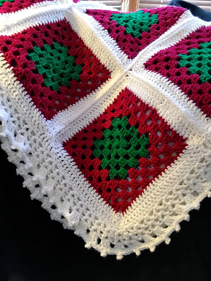 a crocheted blanket is sitting on a chair