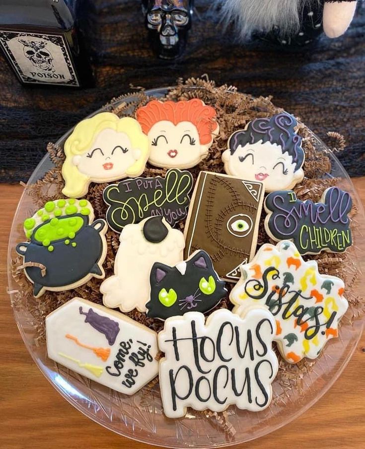 decorated cookies in the shape of children's books on a clear plate with writing