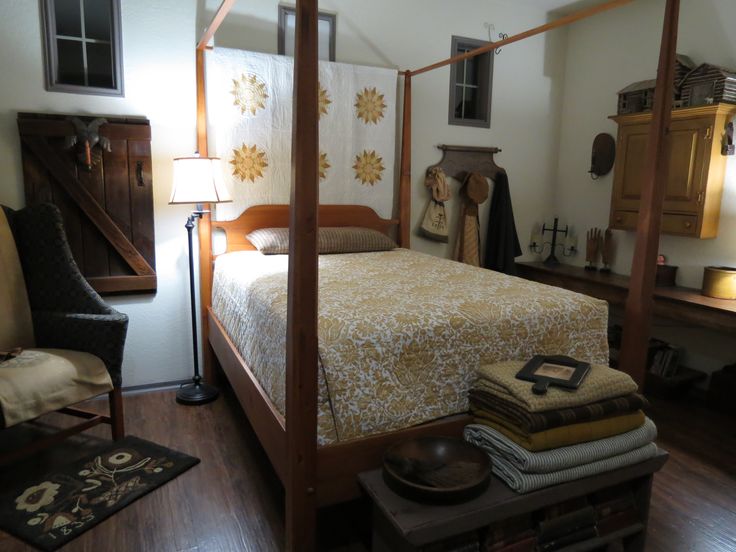 a bedroom with a four poster bed and wooden floors