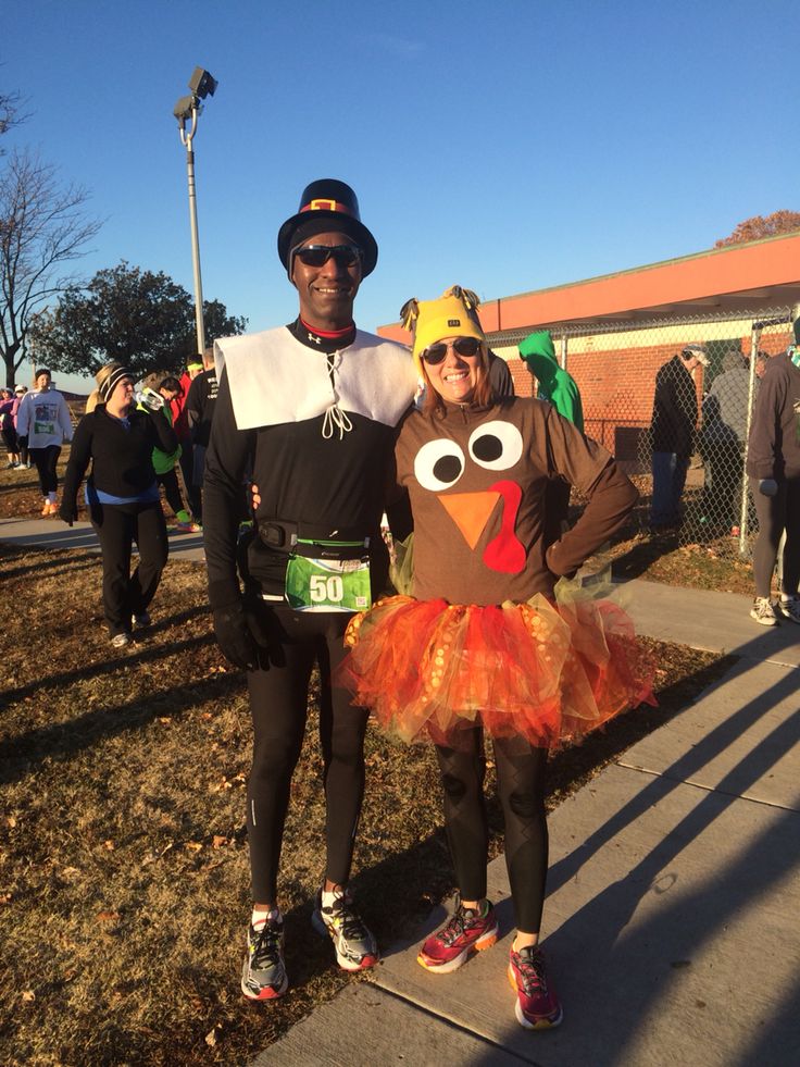 a man and woman dressed up as turkeys for a race run in the park