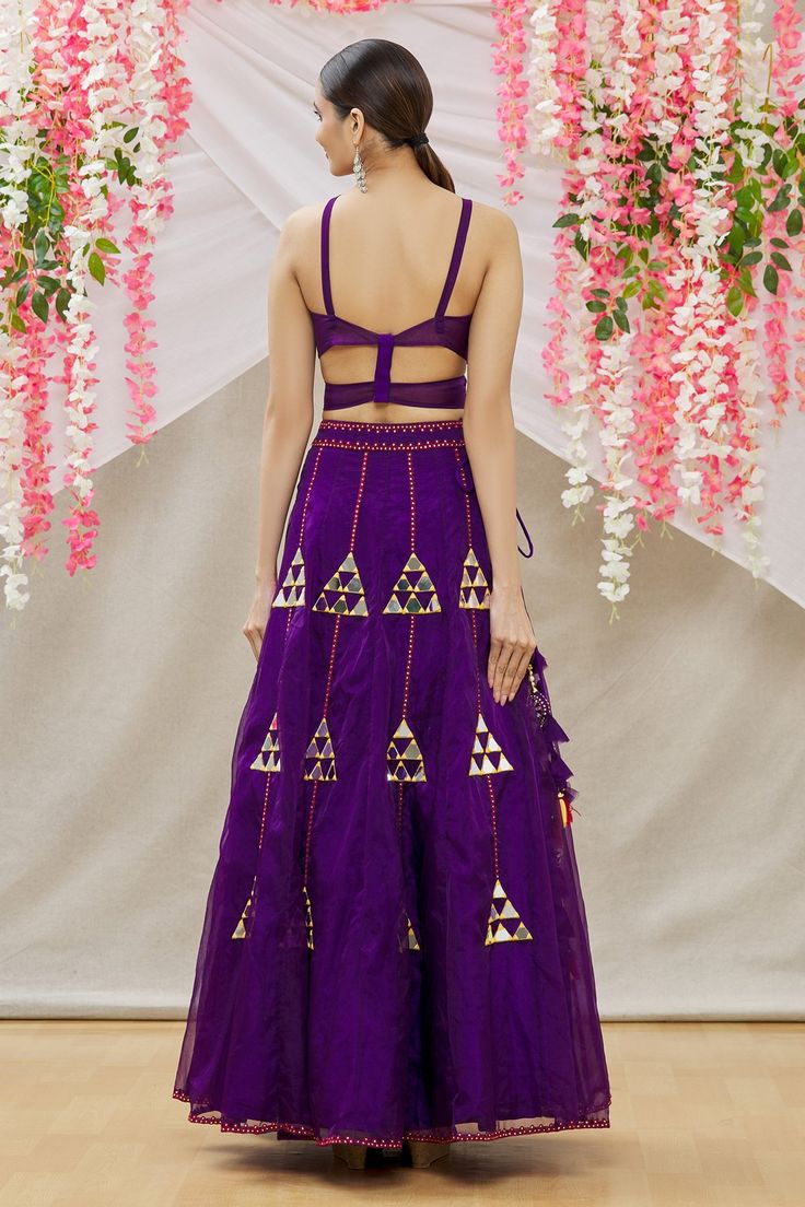 Purple organza lehenga with mirror and swarovski embroidery. Comes with V neck embroidered blouse and scallop hem dupatta.
Component: 3
Pattern: Embroidered
Type Of Work: Swaroski and mirror work 
Neckline: V Neck
Sleeve Type: Sleeveless
Fabric: Blouse:Crepe; Lehenga:Organza; Dupatta:Soft Net
Color: Purple
Other Details: 
Side tassel tie-up lehenga
Occasion: Sangeet - Aza Fashions Swarovski Embroidery, Crepe Lehenga, Organza Lehenga, Embroidered Lehenga, Scallop Hem, Purple Blouse, Organza Dupatta, Mirror Work, Scalloped Hem