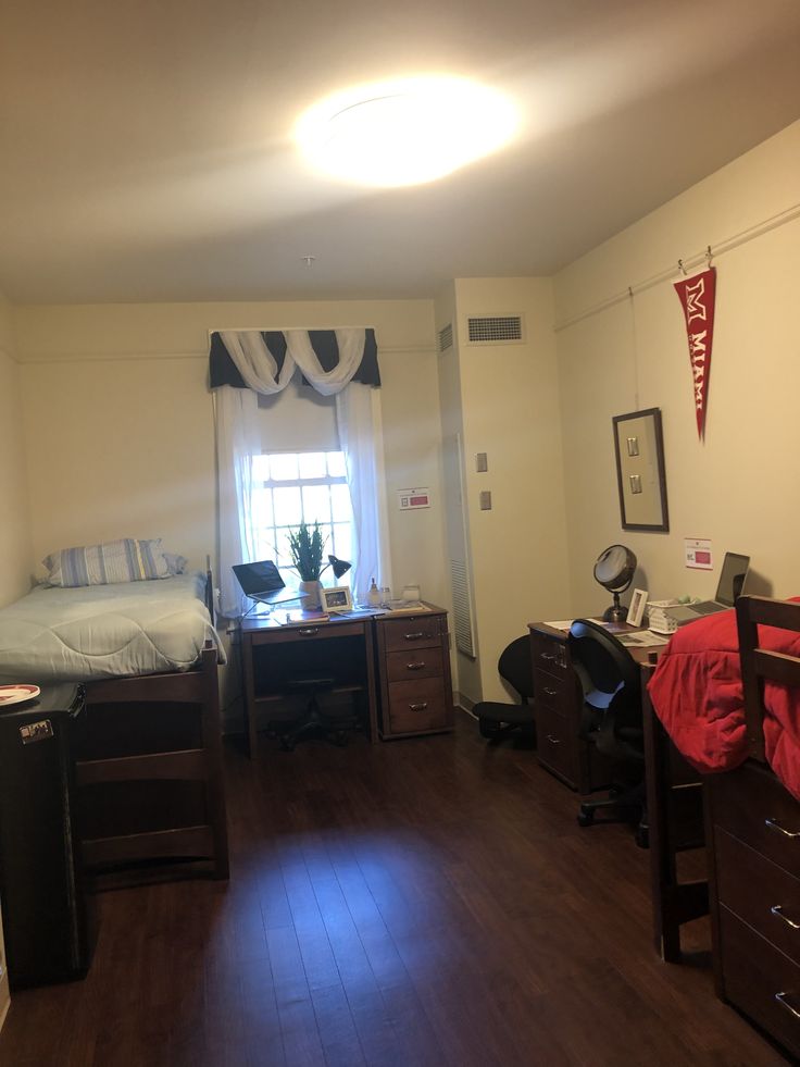 a bedroom with wood floors and white walls